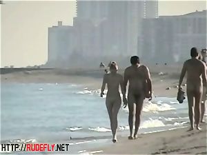 peeping at a steamy nudist couple on the beach